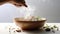 a hand sprinkling herbs over a bowl of steaming food