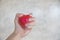 Hand squeezing red rubber heart