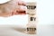 Hand stacking wooden toy blocks with words step by step