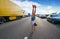 Hand stand girl in a traffic jam road