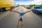 Hand stand girl in a traffic jam road
