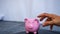 Hand stealing money from piggy bank, un healty saving