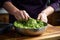 hand stirring freshly made guacamole