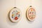 hand-stitched embroidery hoops on a wall