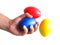 Hand and stress balls colored yellow, red, blue, squeeze ball for hand exercise.