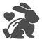 Hand stroking rabbit and heart, animals care solid icon, pets care concept, love bunny vector sign on white background