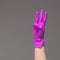 Hand in surgical glove shows three fingers on neutral background. Copy space.