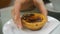 Hand takes apate de Nata close-up - traditional Portuguese dessert on platter slow motion