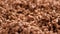 Hand takes dry chocolate cereal rice flakes close up.