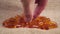 A hand takes a lecithin supplement capsule on a rough rustic burlap napkin close-up.