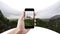 Hand taking photo panorama view of Neuschwanstein Castle, famous place and travel destination in Fussen, Germany