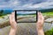 Hand taking picture with mobile at Green Terraced Rice Field