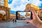 Hand taking picture with a smartphone in Bologna, Piazza Maggiore