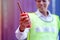 Hand of technician woman hold and shows red walky-talky in cargo container area with concept of good communication