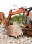 the hand and teeth of orange rusty, worn out bulldozer excavators