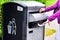 Hand throwing garbage in empty recycling bin