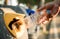 Hand throwing plastic bottle in recycling bin, global warming