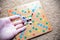 Hand throwing white dice background colorful blurred Board game. The dynamic moment of the game, selective focus.