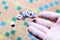 Hand throwing white dice background colorful blurred Board game. The dynamic moment of the game, selective focus.