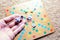 Hand throwing white dice background colorful blurred Board game. The dynamic moment of the game, selective focus.