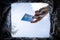 Hand throws credit card into trash bin with package on blue background, bottom view. concept of abandoning bank transactions and