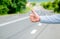 Hand thumb up gesture try stop car road background. Thumb or hand gesture hitchhiking. Make sure you know right gestures