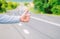 Hand thumb up gesture try stop car road background. Thumb or hand gesture hitchhiking. Make sure you know right gestures