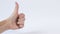 Hand with thumbs up on a white background close up