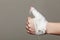 Hand tied elastic bandage on gray background
