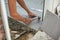 Hand of tiler laying and use mallet knocking granite tile on floor