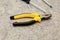 Hand tool yellow pliers close-up part screwdriver blurred background industrial design decoration web design