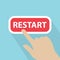 Hand touching restart button