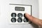 Hand touching screen a hotel thermostat knob to set temperature