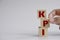 Hand touching wooden cube block with letter KPI