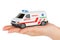 Hand with toy ambulance car