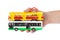 Hand with toy bus and tram