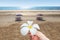 Hand with tropical flower. Sand beach