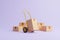 Hand truck and brown cardboard boxes on pastel lilac background