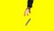 Hand trying to catch flying smartphone.  Isolated on yellow background. Addicted to modern technologies