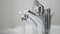 Hand Turn On Tap Water on Sink, Faucet, Woman Let Water Running for Washing in Bathroom, Inundation