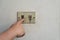 Hand turning the old electrical switches off. Power on/off switches. danger