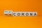 Hand turns cubes and changes the expression `pre corona` to `post corona`. Covid-19 pandemic concept. Beautiful orange backgro