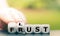 Hand turns dice and changes the German word `Frust` `frustration` to `Lust` `Lust` in English.