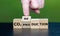Hand turns wooden cube and changes the expression \\\'CO2 production\\\' to \\\'CO2 reduction