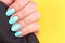 Hand with turquoise, mint blue nails