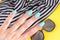 Hand with turquoise nails
