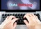 hand type on laptop with data hacking on screen with blur background, internet security concept