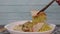 Hand uses chopsticks to pickup tasty Egg Noodles with Grilled Red Pork.