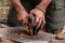 Hand using chaga mushroom to keep fire alive