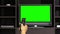 Hand using remote control for switching TV channels on green screen background